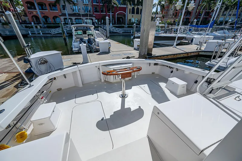 One Of Many Yacht Photos Pics 1999 Post 50 Convertible yacht deck at marina, featuring spacious seating and fishing equipment.