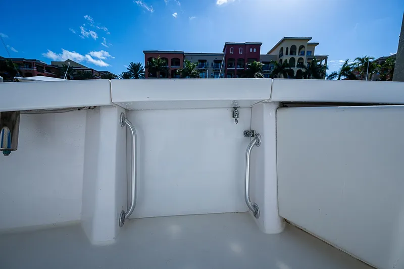One Of Many Yacht Photos Pics 1999 Post 50 Convertible boat deck with railing, buildings in background.