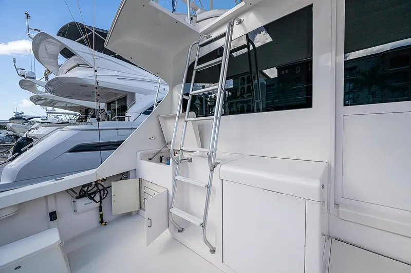 One Of Many Yacht Photos Pics 1999 Post 50 Convertible yacht with ladder and sleek white exterior.