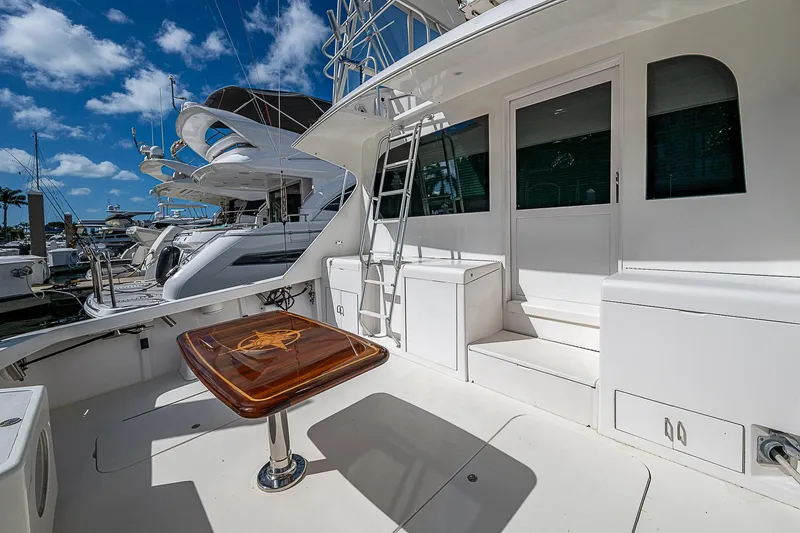 One Of Many Yacht Photos Pics 1999 Post 50 Convertible yacht deck with table, marina view, blue sky.