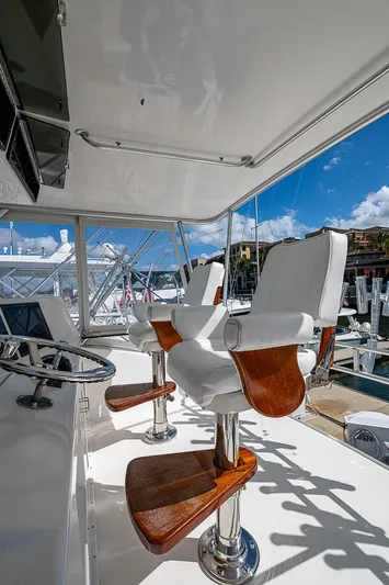 One Of Many Yacht Photos Pics Luxury yacht helm with white leather seats, Post 50 Convertible, 1999 model.