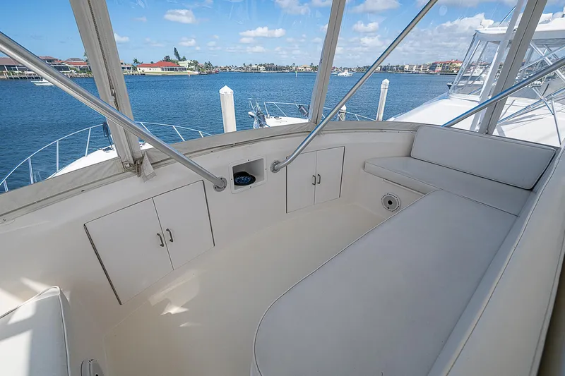 One Of Many Yacht Photos Pics 1999 Post 50 Convertible yacht interior with seating, overlooking serene waterfront.