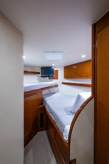 One Of Many Yacht Photos Pics 1999 Post 50 Convertible yacht interior with cozy twin beds and wooden cabinetry.