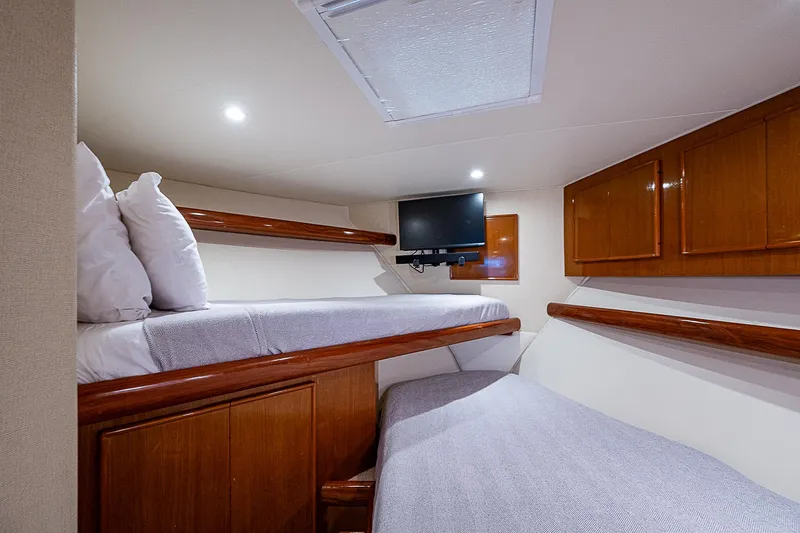 One Of Many Yacht Photos Pics Cozy cabin interior of 1999 Post 50 Convertible yacht with twin beds and TV.