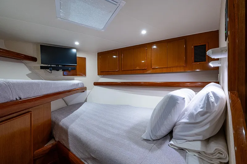 One Of Many Yacht Photos Pics Luxurious cabin interior of 1999 Post 50 Convertible yacht with cozy bedding and TV.
