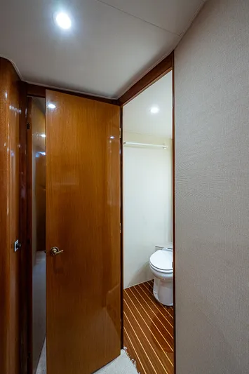 One Of Many Yacht Photos Pics 1999 Post 50 Convertible yacht bathroom with wooden door and flooring.