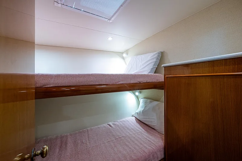 One Of Many Yacht Photos Pics 1999 Post 50 Convertible yacht cabin with cozy bunk beds and soft lighting.