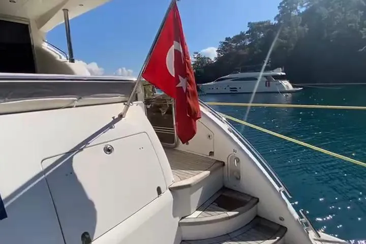  Yacht Photos Pics Luxury yacht Princess 21M (2007) with Turkish flag, docked in scenic waters.