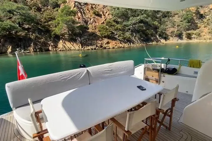  Yacht Photos Pics Luxury yacht Princess 21M (2007) with outdoor dining area, scenic coastal view.