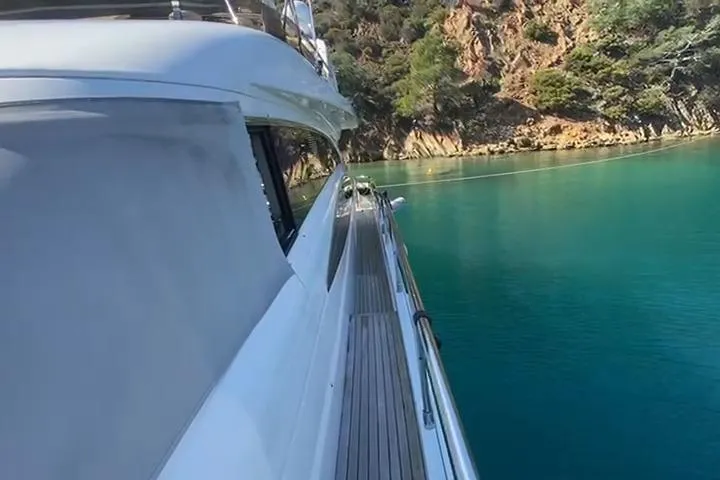  Yacht Photos Pics 2007 Princess 21M yacht cruising near rocky coastline with clear turquoise water.