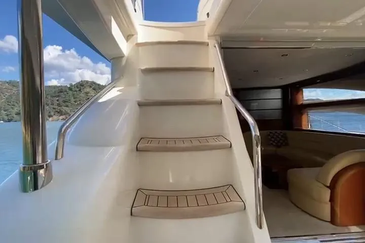  Yacht Photos Pics Staircase on 2007 Princess 21M yacht leading to upper deck, with luxurious interior view.