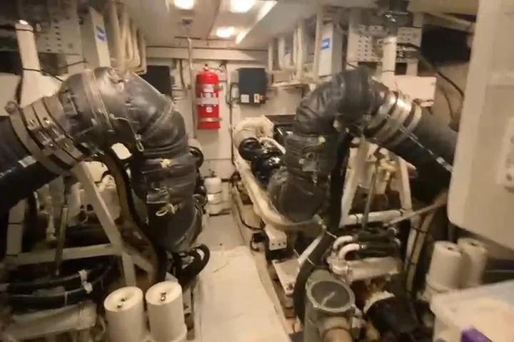  Yacht Photos Pics Engine room of a 2007 Princess 21M yacht with visible machinery and fire extinguisher.
