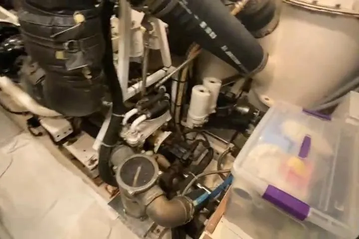  Yacht Photos Pics Engine room of a 2007 Princess 21M yacht, featuring mechanical components and storage box.