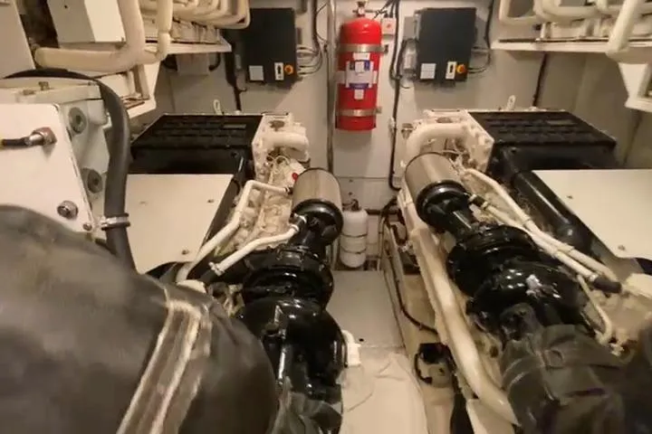  Yacht Photos Pics Engine room of a 2007 Princess 21M yacht with visible machinery and fire extinguisher.