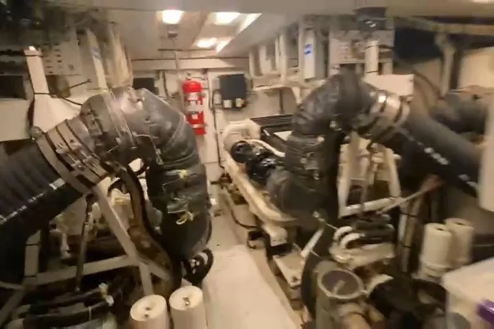  Yacht Photos Pics Engine room of a 2007 Princess 21M yacht, featuring large exhaust pipes and equipment.