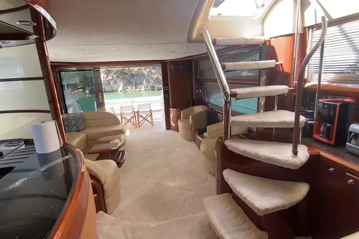  Yacht Photos Pics Luxurious interior of a 2007 Princess 21M yacht with elegant furnishings and spiral staircase.
