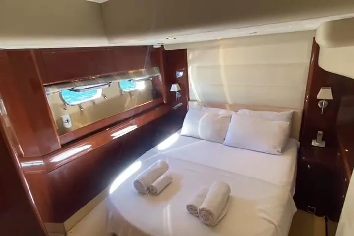 Yacht Photos Pics Luxurious cabin interior of 2007 Princess 21M yacht with bed and porthole view.