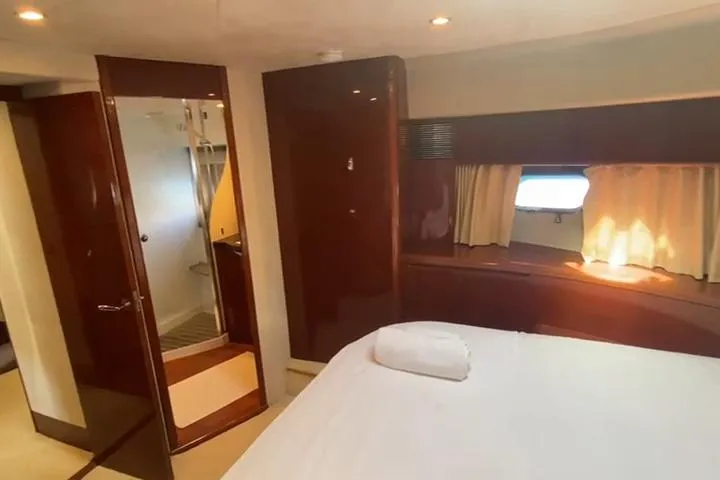  Yacht Photos Pics Luxurious cabin interior of 2007 Princess 21M yacht with bed and window view.