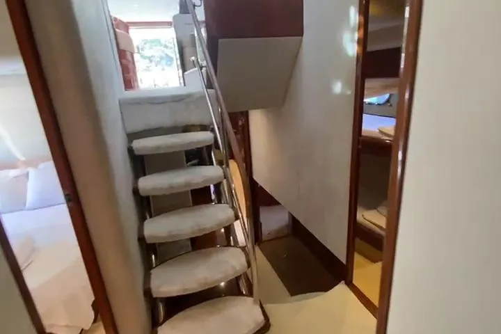  Yacht Photos Pics Luxurious interior of 2007 Princess 21M yacht with carpeted stairs and elegant design.