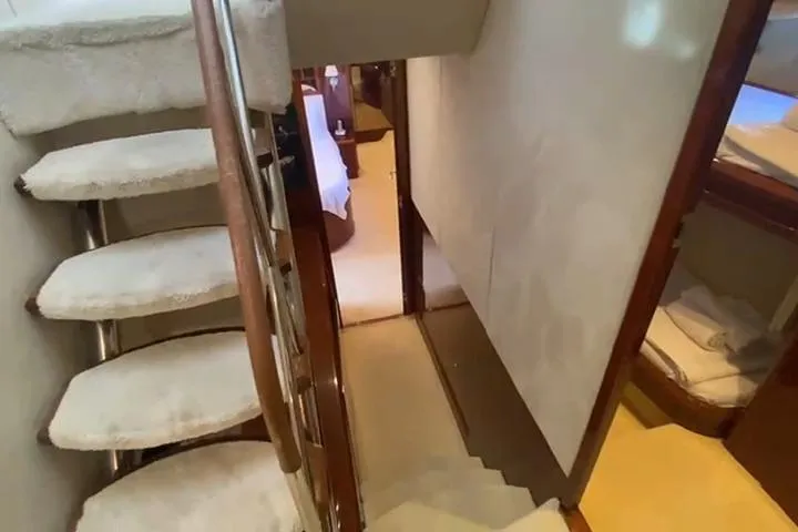  Yacht Photos Pics Luxurious interior staircase of a 2007 Princess 21M yacht, featuring plush carpeting.