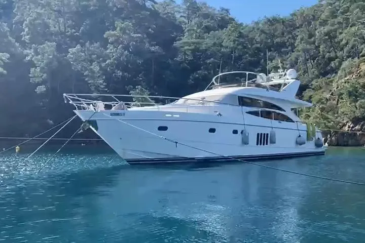  Yacht Photos Pics Luxury Princess 21M yacht from 2007 anchored in serene, clear blue waters.