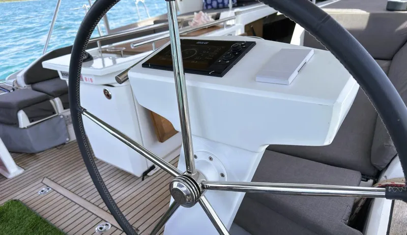Batesea Yacht Photos Pics Steering wheel of 2020 Beneteau Oceanis 46.1 yacht with modern navigation controls.