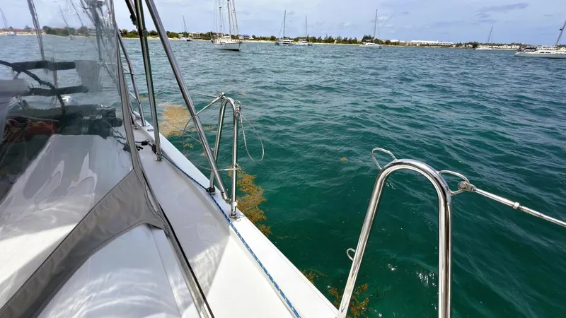 Batesea Yacht Photos Pics Beneteau Oceanis 46.1 sailboat on calm waters, 2020 model, with scenic coastal view.