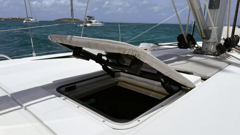 Batesea Yacht Photos Pics Open hatch on 2020 Beneteau Oceanis 46.1 sailboat, with ocean view in background.