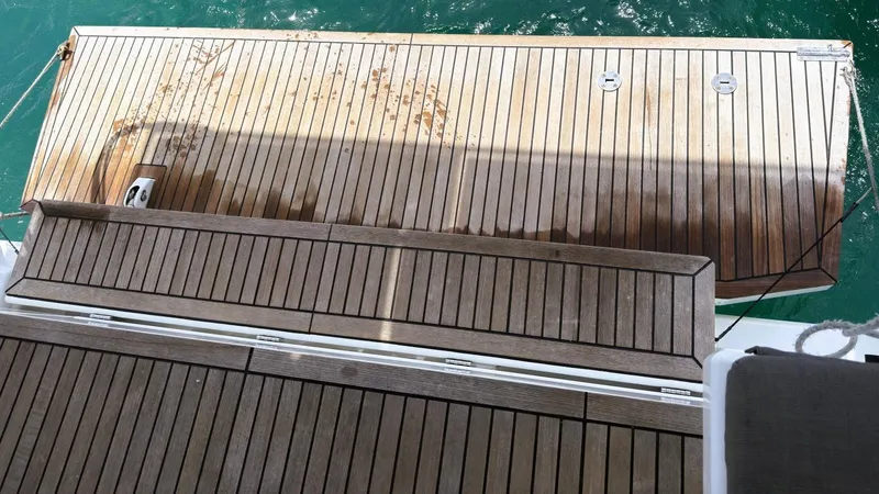 Batesea Yacht Photos Pics Teak deck of 2020 Beneteau Oceanis 46.1 yacht with turquoise water background.