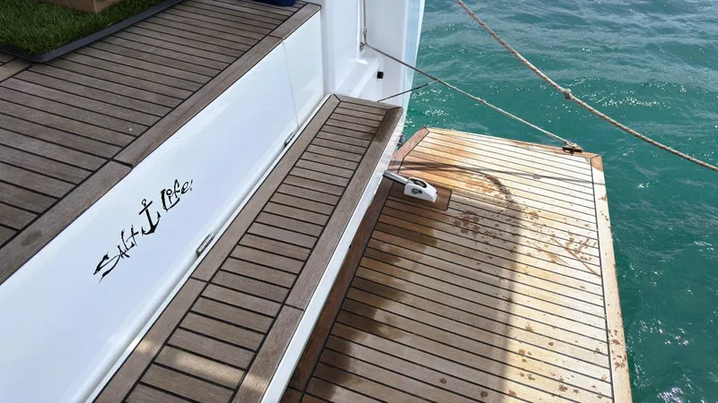 Batesea Yacht Photos Pics Beneteau Oceanis 46.1 yacht deck with wooden steps, 2020 model, near turquoise water.