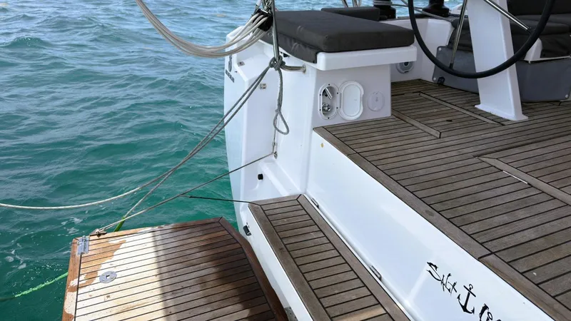 Batesea Yacht Photos Pics Beneteau Oceanis 46.1 yacht deck, 2020 model, with teak flooring and ocean backdrop.