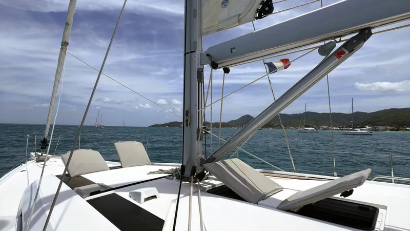 Batesea Yacht Photos Pics 2020 Beneteau Oceanis 46.1 sailboat on calm sea with scenic coastal backdrop.
