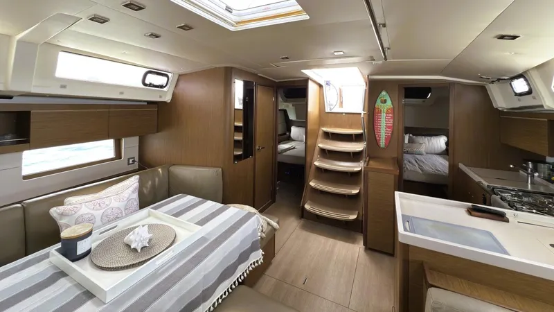 Batesea Yacht Photos Pics Interior of 2020 Beneteau Oceanis 46.1 yacht, featuring modern dining and kitchen area.