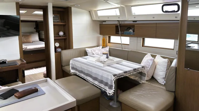 Batesea Yacht Photos Pics Interior of 2020 Beneteau Oceanis 46.1 yacht with cozy dining area and modern design.