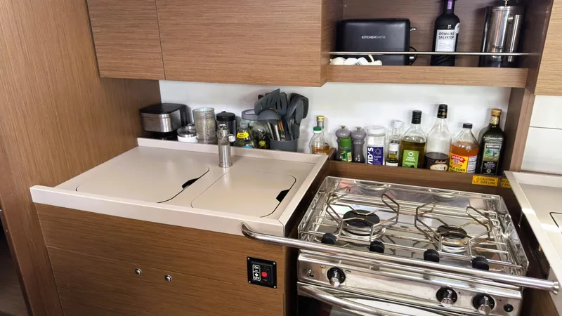 Batesea Yacht Photos Pics Galley kitchen in 2020 Beneteau Oceanis 46.1 yacht with stove and storage.