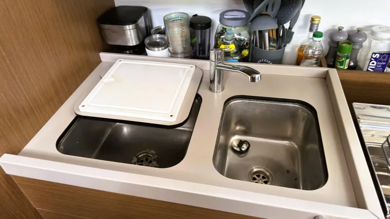 Batesea Yacht Photos Pics Galley sink area on 2020 Beneteau Oceanis 46.1 yacht with dual basins and faucet.