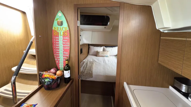 Batesea Yacht Photos Pics Interior of 2020 Beneteau Oceanis 46.1 yacht with cozy bedroom and kitchen area.