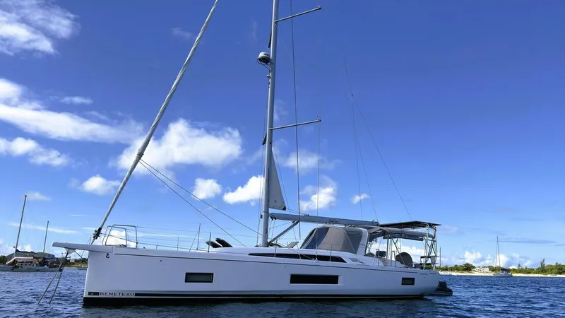 Batesea Yacht Photos Pics 2020 Beneteau Oceanis 46.1 sailboat on calm water under a clear blue sky.