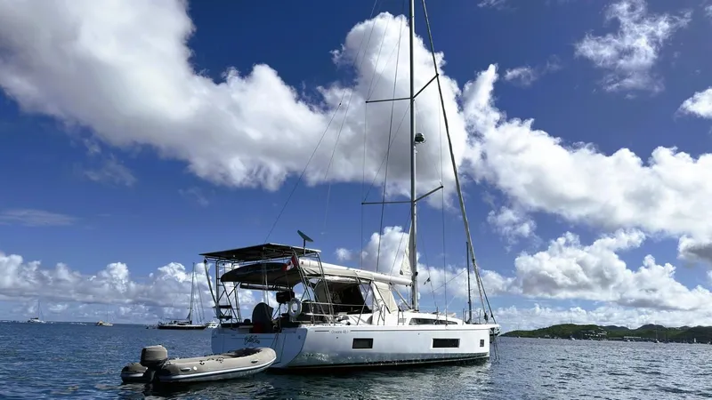 Batesea Yacht Photos Pics 2020 Beneteau Oceanis 46.1 sailboat anchored under a bright blue sky.