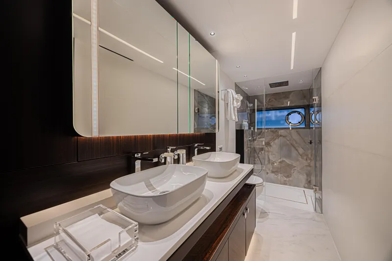 Hideout Yacht Photos Pics Luxurious bathroom in 2025 Sunseeker 88 Yacht with dual sinks and modern shower.