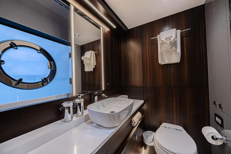 Hideout Yacht Photos Pics Luxurious bathroom in 2025 Sunseeker 88 Yacht with modern fixtures and ocean view.