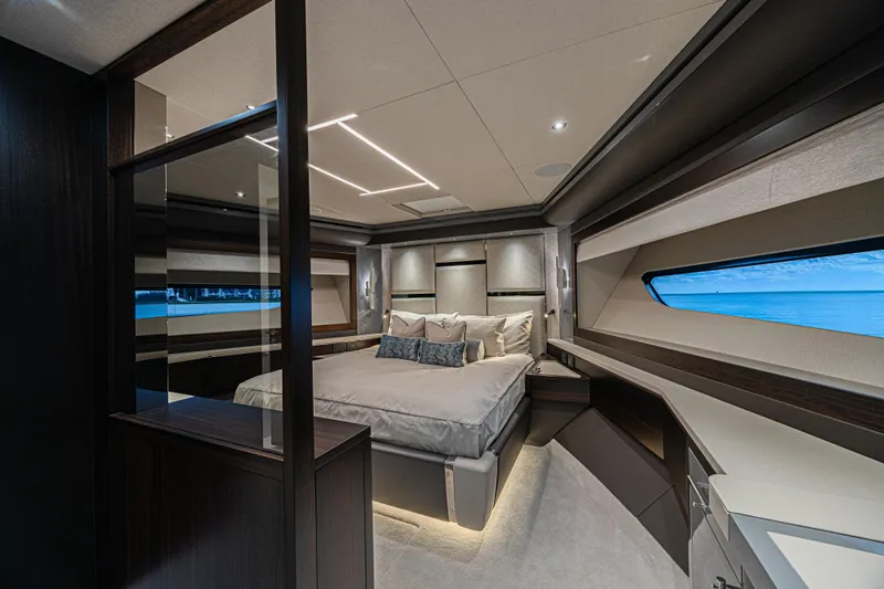 Hideout Yacht Photos Pics Luxurious bedroom interior of 2025 Sunseeker 88 Yacht with ocean view.