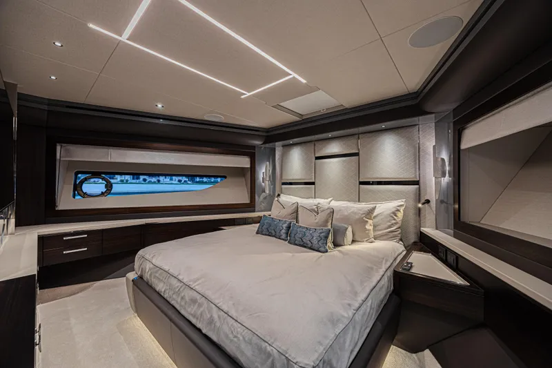 Hideout Yacht Photos Pics Luxurious bedroom interior of 2025 Sunseeker 88 Yacht with modern design and elegant furnishings.