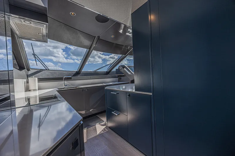 Hideout Yacht Photos Pics Modern kitchen interior of 2025 Sunseeker 88 Yacht with sleek design and ocean view.