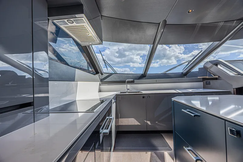 Hideout Yacht Photos Pics Modern kitchen interior of 2025 Sunseeker 88 Yacht with sleek design and panoramic windows.