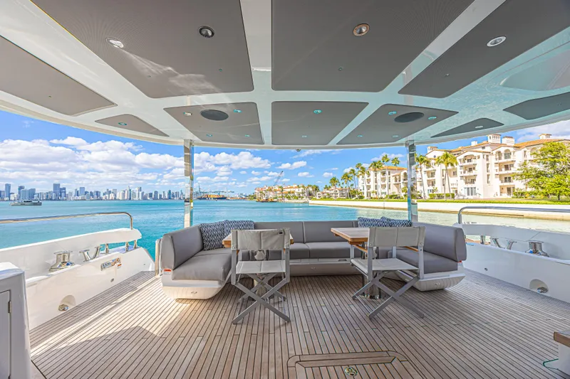 Hideout Yacht Photos Pics Luxurious Sunseeker 88 Yacht 2025 with scenic waterfront view and elegant outdoor seating.