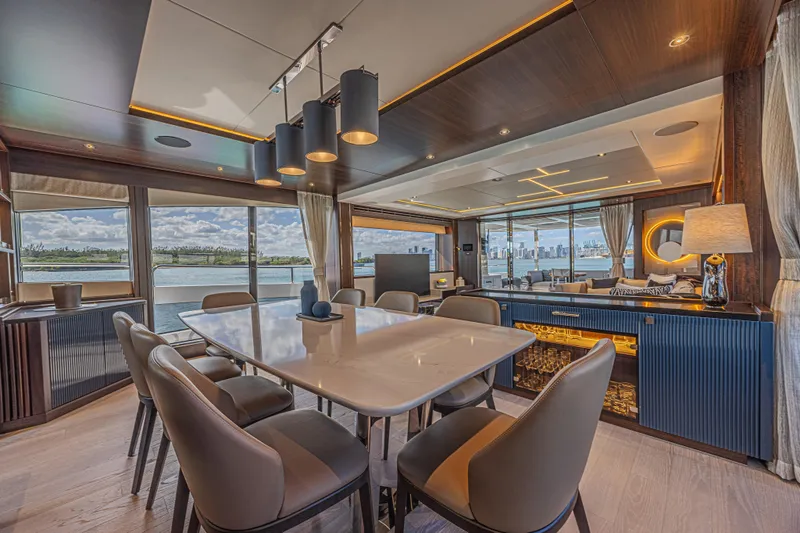Hideout Yacht Photos Pics Luxurious interior of 2025 Sunseeker 88 Yacht with elegant dining area and panoramic windows.