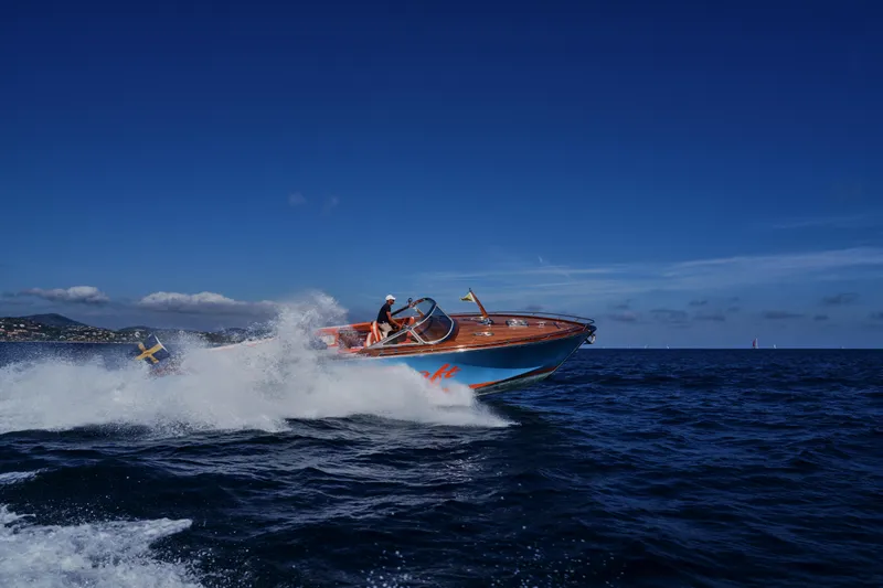  Yacht Photos Pics 2026 J Craft Torpedo 42 speeding on open sea under clear blue sky.