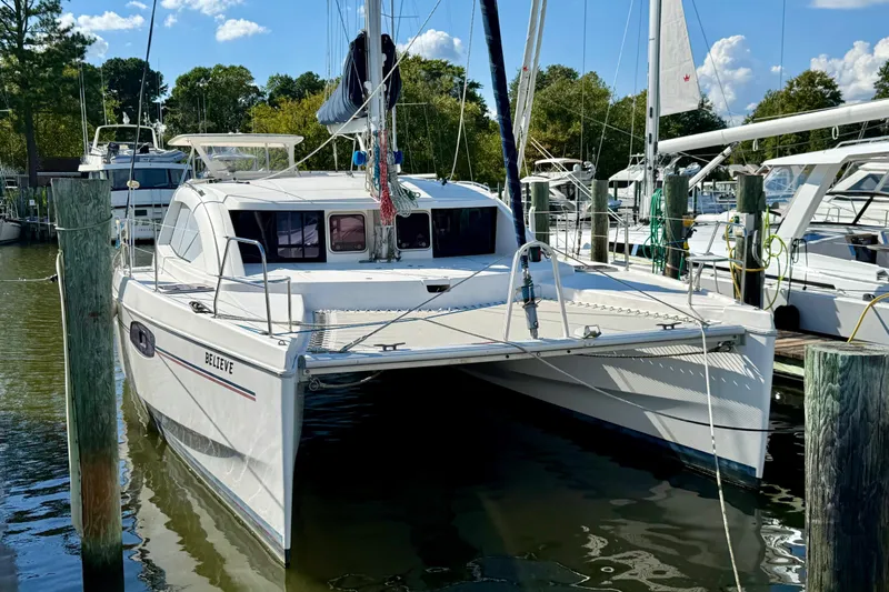  Yacht Photos Pics 2012 Leopard 39 catamaran docked at marina, surrounded by trees and boats.