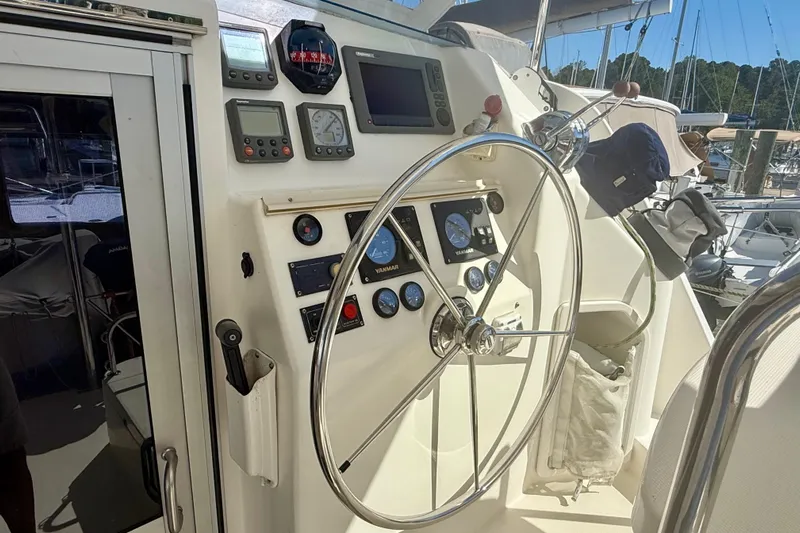  Yacht Photos Pics Steering wheel and control panel of 2012 Leopard 39 yacht in marina setting.